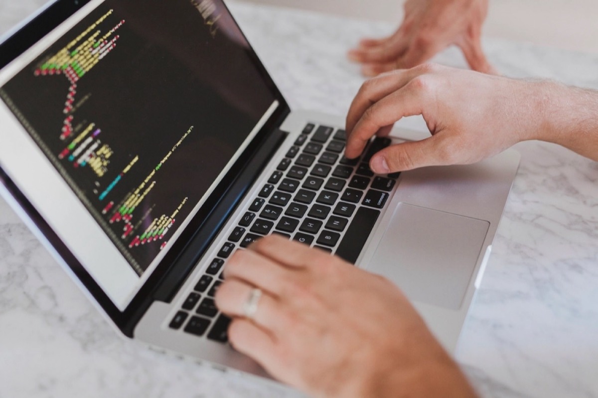 Developer writing code on a laptop